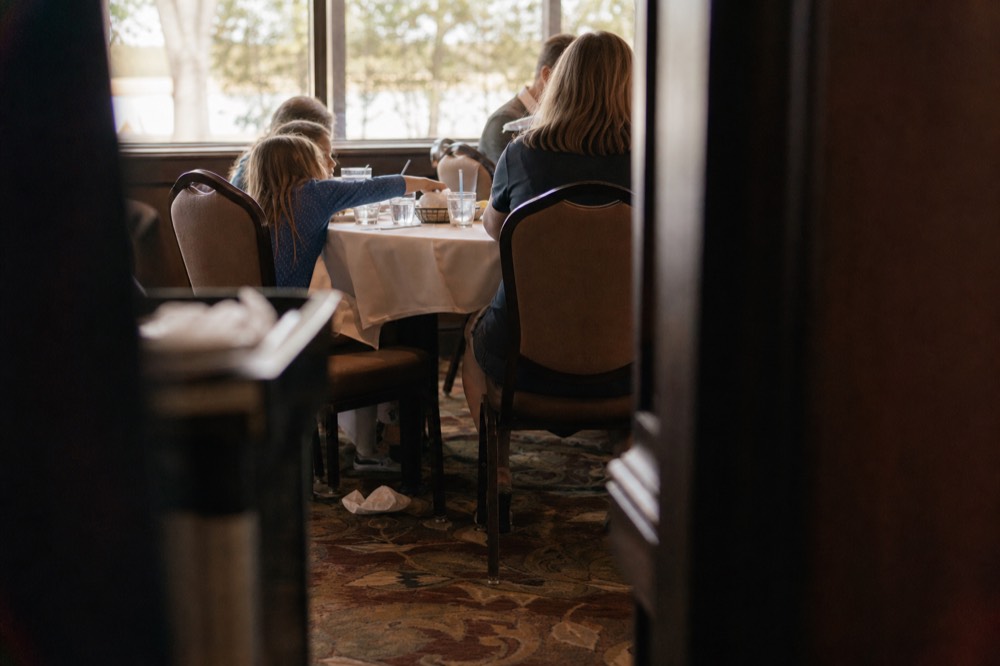 Family sharing a meal at a table on a Seine dinner cruise, no text, no logos, no people