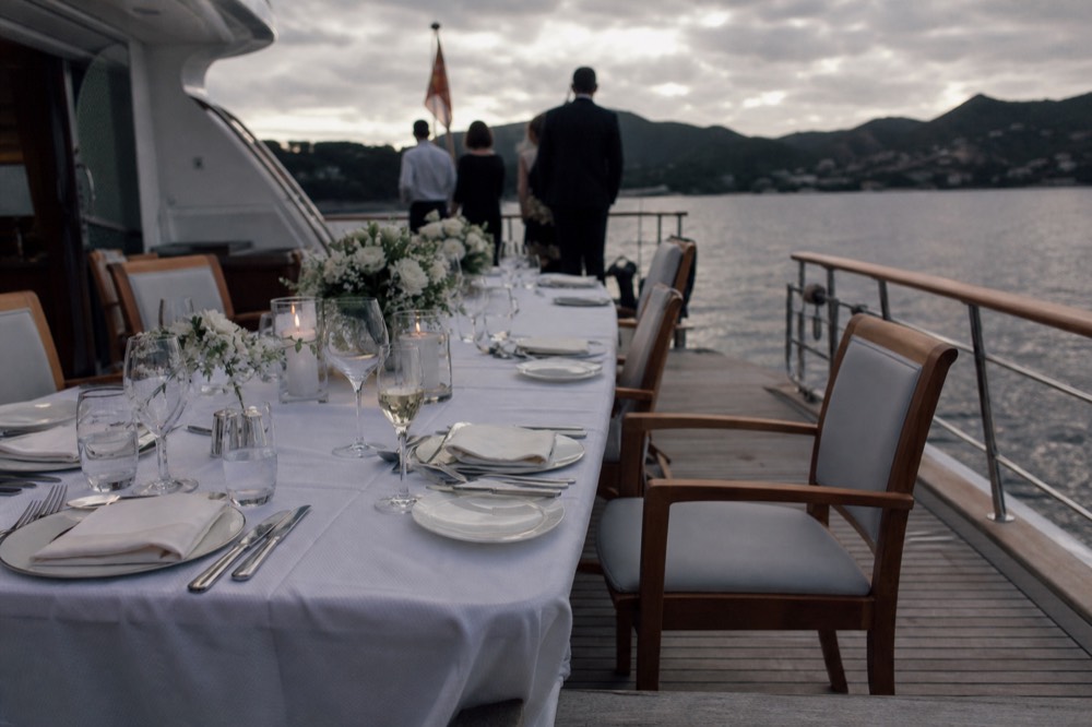Diners at a formal table setting aboard a luxury dinner cruise boat, no text, no logos, no people