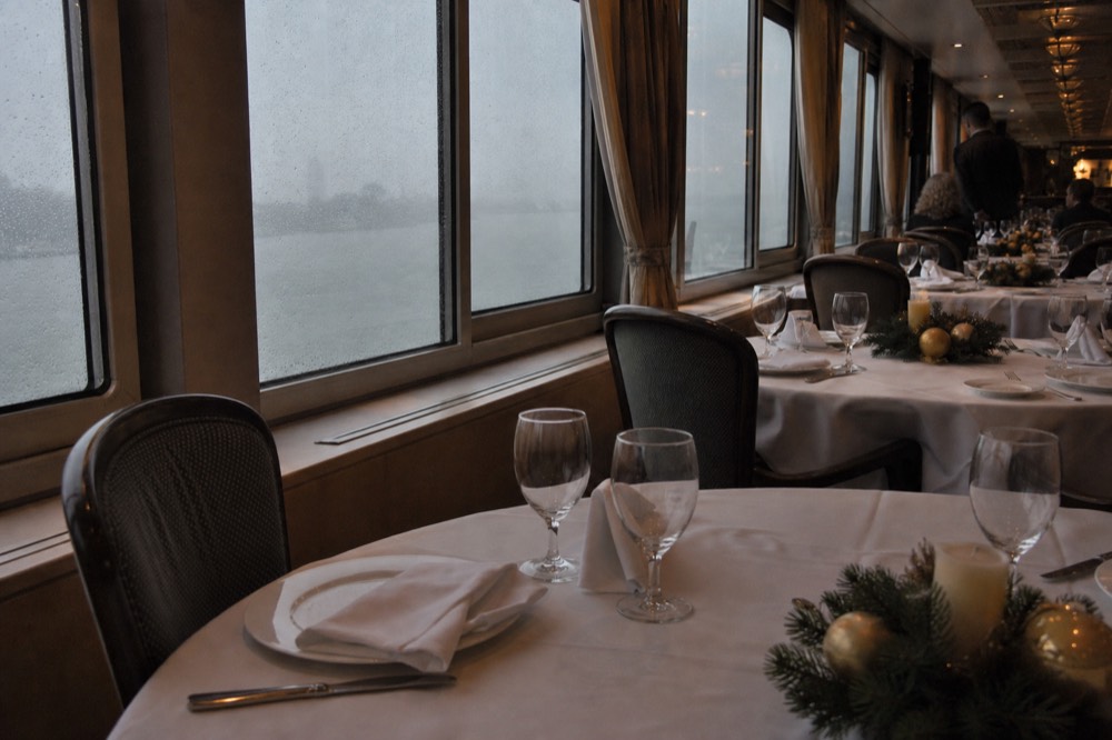 A festively decorated dinner cruise dining room with set tables, no text, no logos, no people